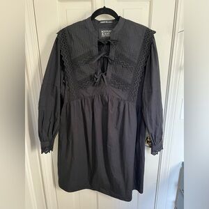 Black eyelet lace dress with bows down the front.